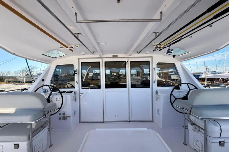 Slide: The Image of 2020 Seawind 1260 catamaran cockpit with dual steering wheels and spacious seating. - 107