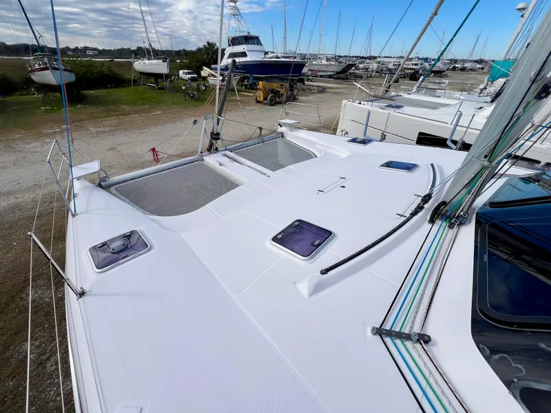 Slide: The Image of 2020 Seawind 1260 catamaran with sleek design, docked among other boats. - 11