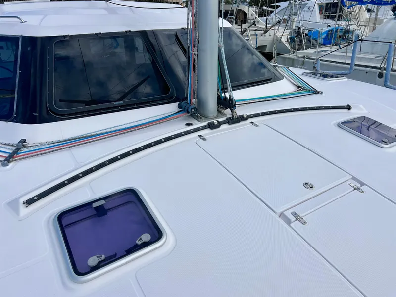 Slide: The Image of 2020 Seawind 1260 catamaran docked among other sailboats under clear blue sky. - 15