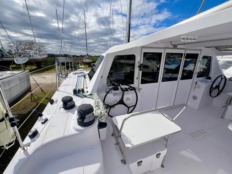 Slide: The Image of Sail with Precision Sails logo on a Seawind 1260, 2020 model, under clear sky. - 17