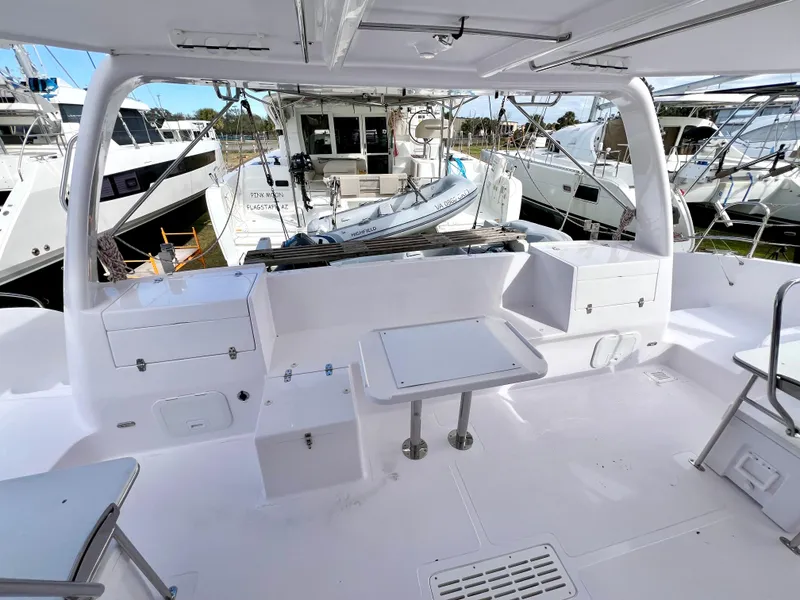 Slide: The Image of 2020 Seawind 1260 catamaran cockpit with dual steering wheels and spacious seating area. - 20