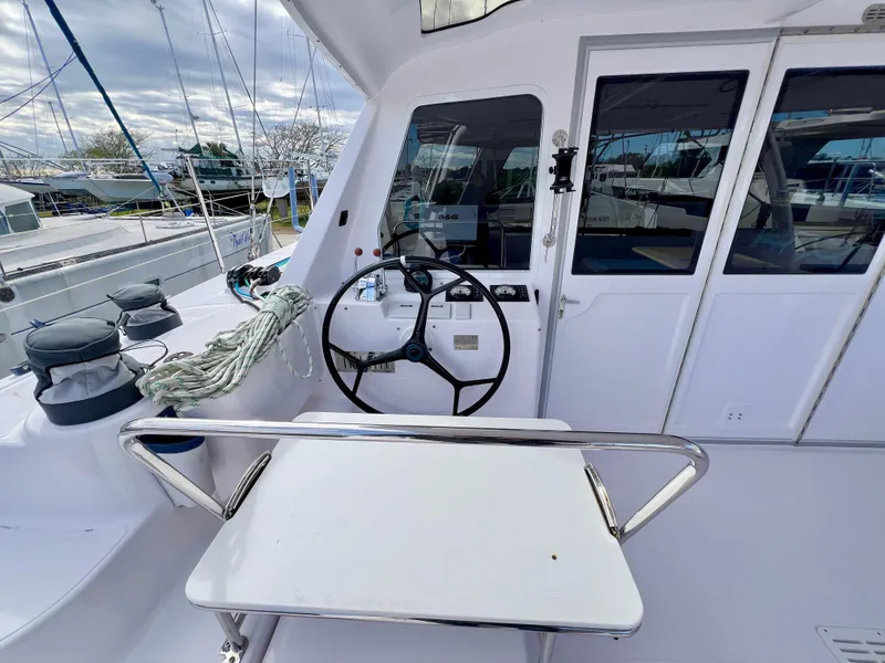 Slide: The Image of 2020 Seawind 1260 catamaran interior with dual helm stations and spacious seating area. - 21