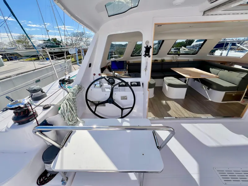 Slide: The Image of Interior view of 2020 Seawind 1260 catamaran, featuring helm and spacious seating area. - 22