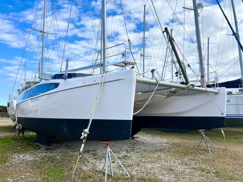 Slide: The Image of 2020 Seawind 1260 catamaran on land, blue sky background, ready for maintenance. - 3