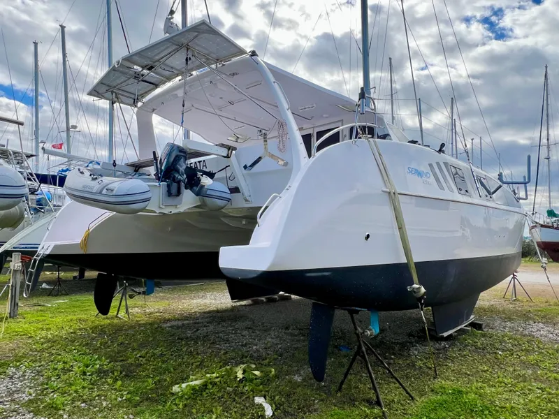 Slide: The Image of Seawind 1260 catamaran, 2020 model, on land with clear blue sky background. - 7