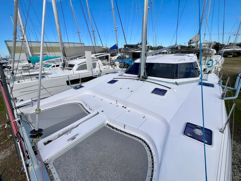 Slide: The Image of 2020 Seawind 1260 catamaran on land, featuring a sleek design and attached dinghy. - 8