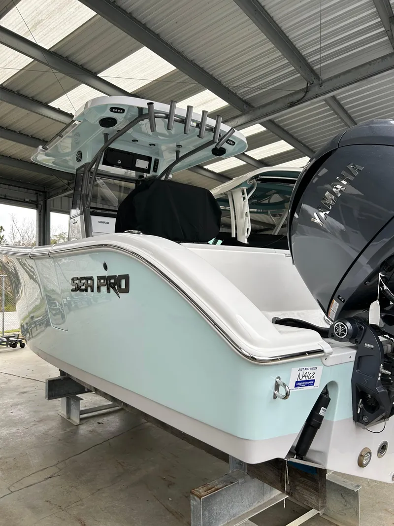 Slide: The Image of 2025 Sea Pro 262 Offshore boat in a covered storage area. - 1