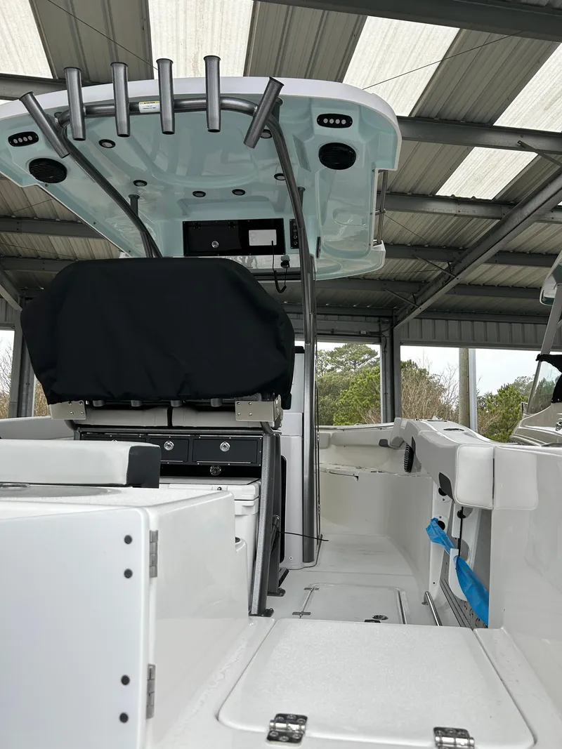 Slide: The Image of 2025 Sea Pro 262 Offshore boat interior under a metal roof, showcasing modern design and equipment. - 6
