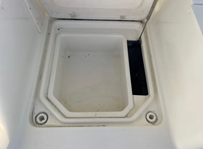 Slide: The Image of Open storage compartment on a 2003 Pursuit 2870 Walkaround boat. - 17
