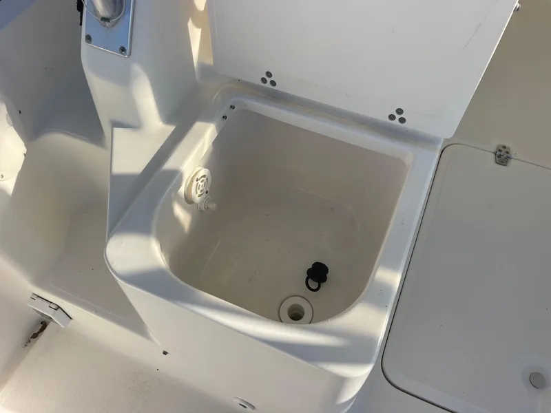 Slide: The Image of 2003 Pursuit 2870 Walkaround boat storage compartment with open lid. - 18