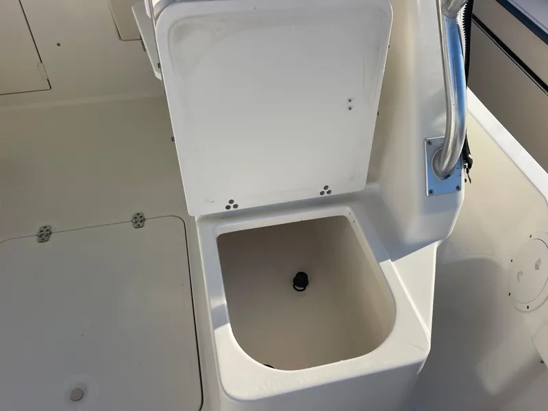 Slide: The Image of 2003 Pursuit 2870 Walkaround boat interior with open storage compartment. - 19