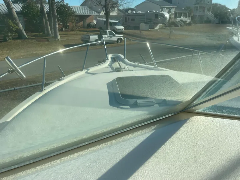 Slide: The Image of 2003 Pursuit 2870 Walkaround boat deck view with windshield and railing. - 23