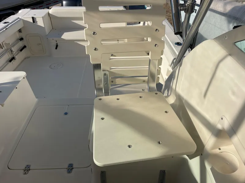 Slide: The Image of 2003 Pursuit 2870 Walkaround boat interior with seating and deck details. - 26