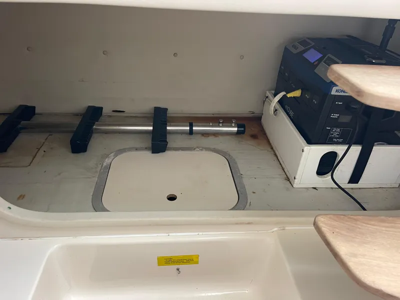 Slide: The Image of 2003 Pursuit 2870 Walkaround interior storage with equipment and generator. - 30