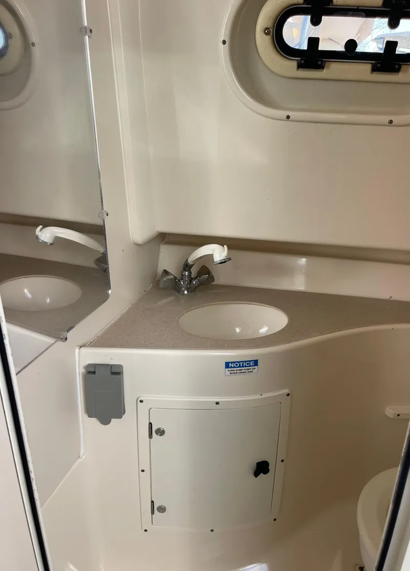 Slide: The Image of 2003 Pursuit 2870 Walkaround boat bathroom with sink and mirror. - 31