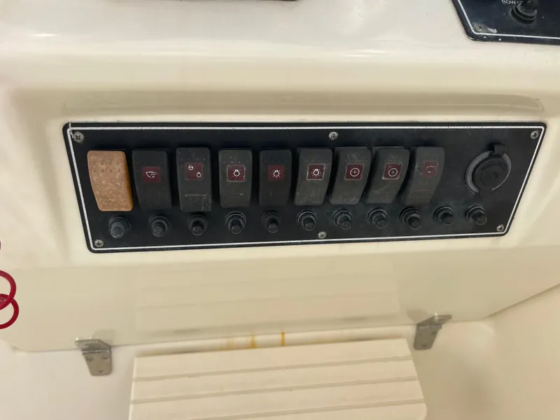 Slide: The Image of Control panel of a 2003 Pursuit 2870 Walkaround boat with multiple switches. - 38