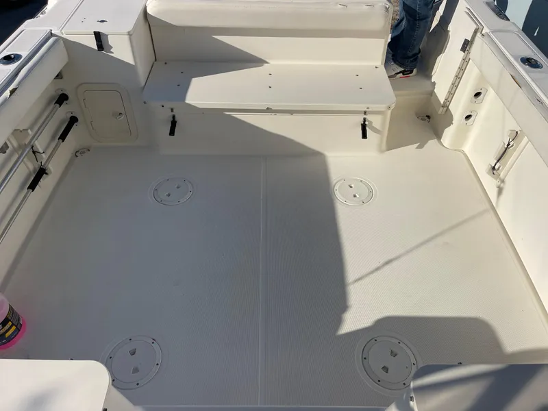 Slide: The Image of 2003 Pursuit 2870 Walkaround boat deck, spacious seating, clean white surface, fishing-ready layout. - 40