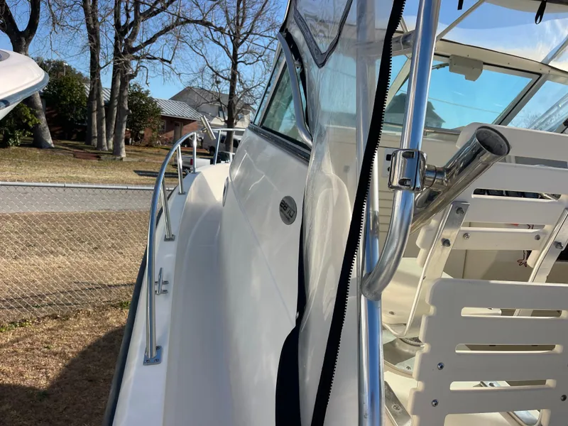 Slide: The Image of 2003 Pursuit 2870 Walkaround boat, side view with railing and clear canopy. - 6