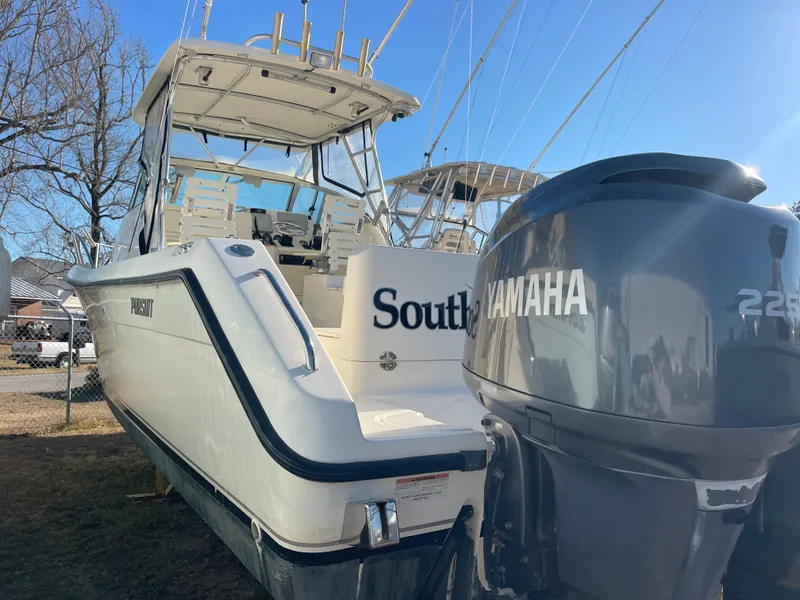 Slide: The Image of 2003 Pursuit 2870 Walkaround boat with Yamaha 225 engine, docked outdoors. - 9