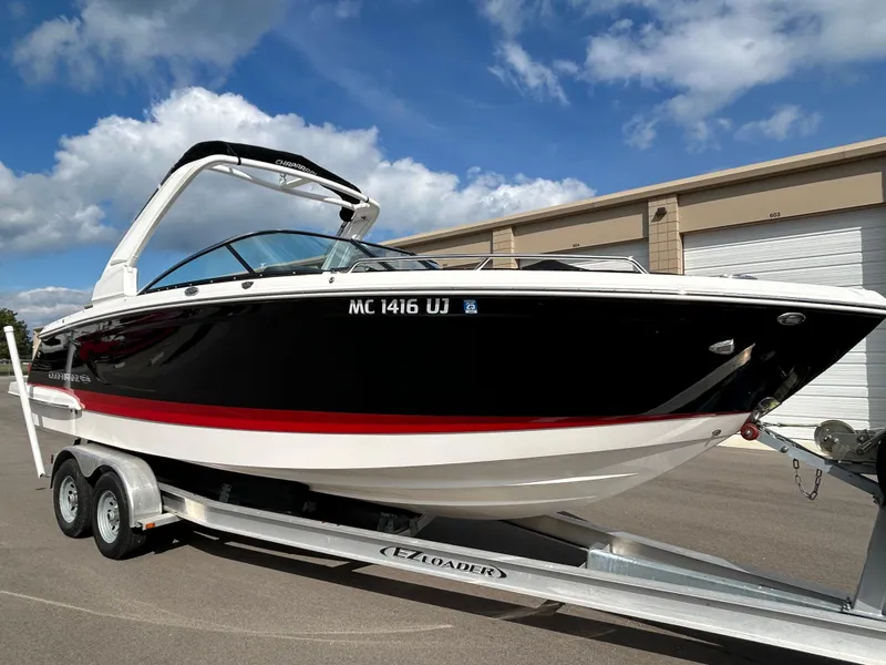 Slide: The Image of 2019 Chaparral 277 SSX boat on trailer, black and white with red stripe, parked outdoors. - 0