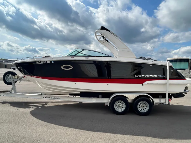 Slide: The Image of 2019 Chaparral 277 SSX boat on trailer under cloudy sky. - 11