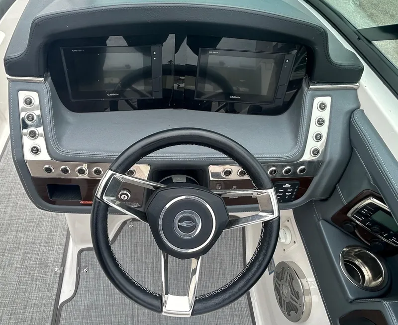 Slide: The Image of 2019 Chaparral 277 SSX dashboard with steering wheel and dual display screens. - 23