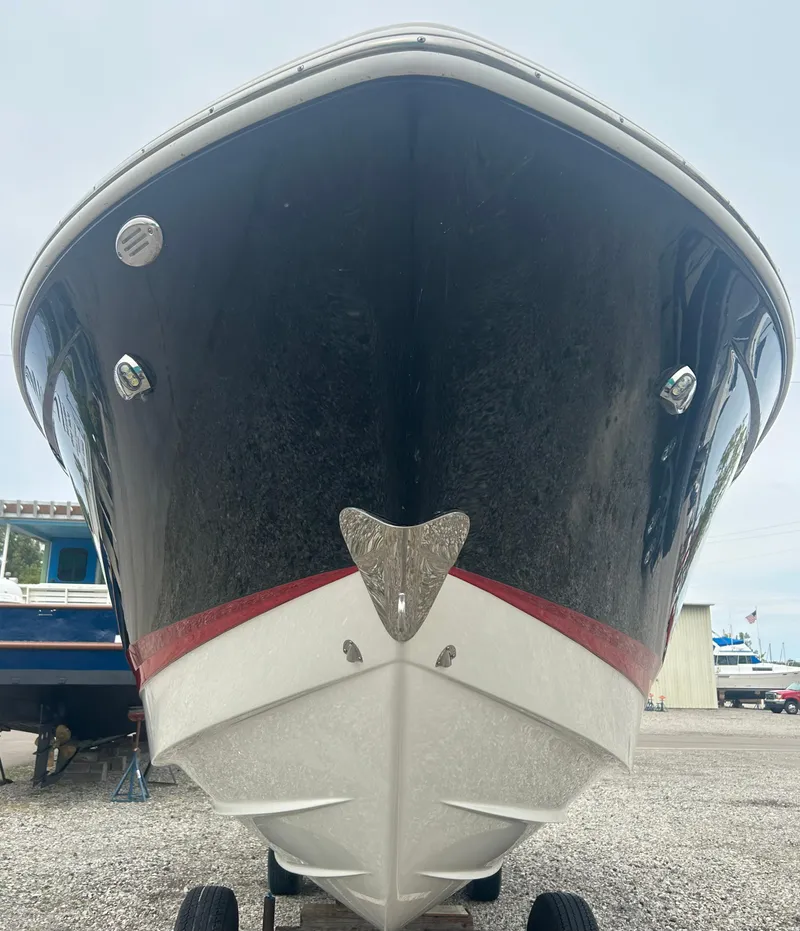 Slide: The Image of 2019 Chaparral 277 SSX boat, front view, black hull with red stripe, on a trailer. - 4