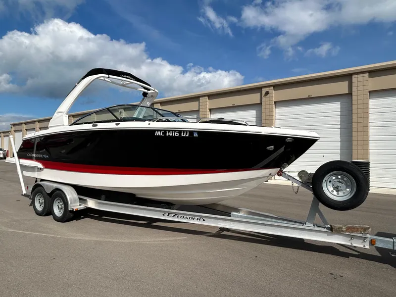 Slide: The Image of 2019 Chaparral 277 SSX boat on trailer, parked outdoors under blue sky. - 9