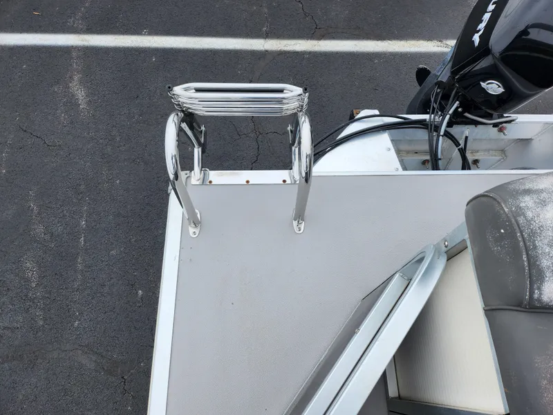 Slide: The Image of Misty Harbor 2085CR Adventure Cruiser 2010 boat deck with ladder and motor. - 14