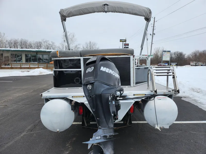 Slide: The Image of 2010 Misty Harbor 2085CR Adventure Cruiser with Mercury 60 engine, parked on snowy pavement. - 2