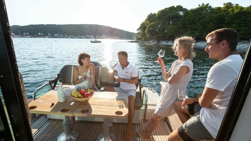 Slide: The Image of People enjoying a sunny day on a 2025 Saxdor 320 GTC boat. - 13