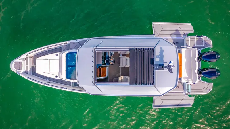 Slide: The Image of Aerial view of 2025 Saxdor 320 GTC boat on green water. - 4