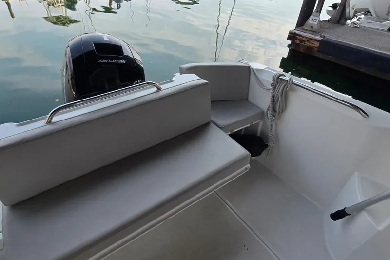 Slide: The Image of 2022 Beneteau Antares 7 boat interior with seating and Mercury outboard motor. - 11