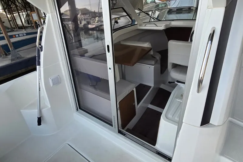 Slide: The Image of Interior view of 2022 Beneteau Antares 7 boat, showcasing seating and table arrangement. - 10