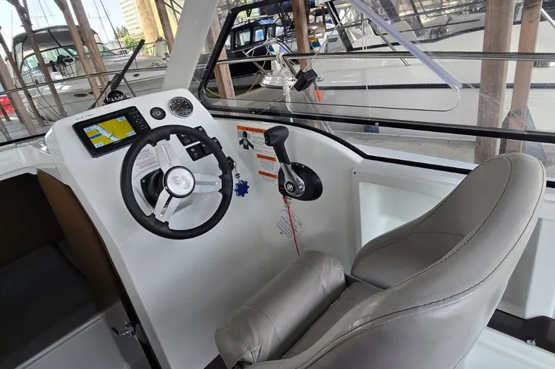 Slide: The Image of Interior helm of 2022 Beneteau Antares 7 with steering wheel and navigation display. - 16