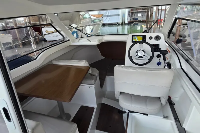 Slide: The Image of Interior of 2022 Beneteau Antares 7 boat with steering wheel and seating area. - 13