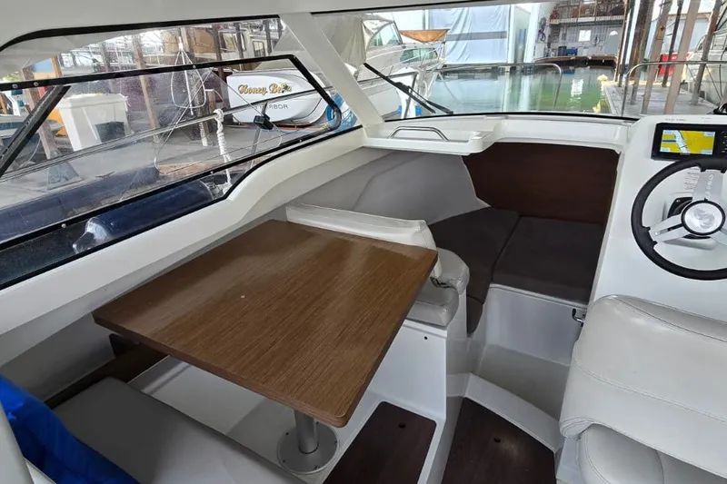 Slide: The Image of Interior of 2022 Beneteau Antares 7 boat with seating and navigation area. - 17