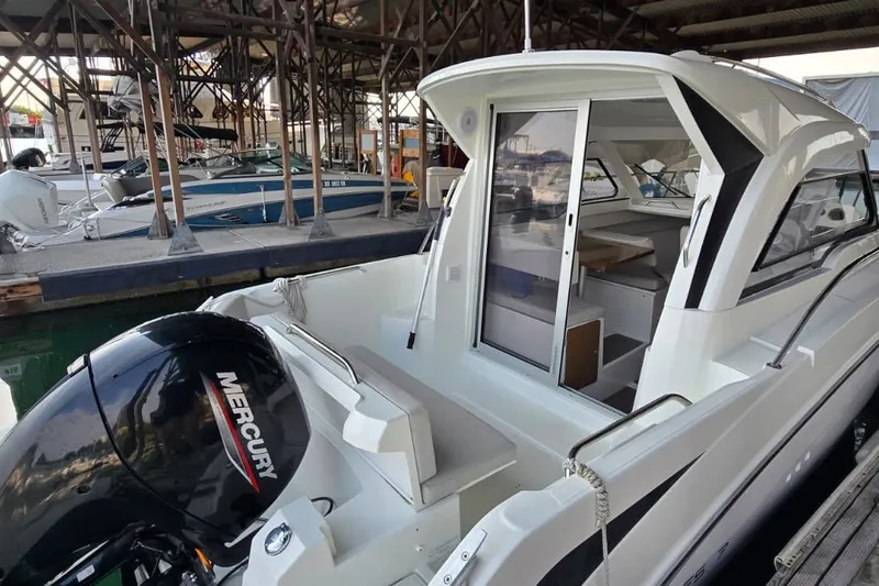 Slide: The Image of 2022 Beneteau Antares 7 boat with Mercury engine docked in marina. - 9