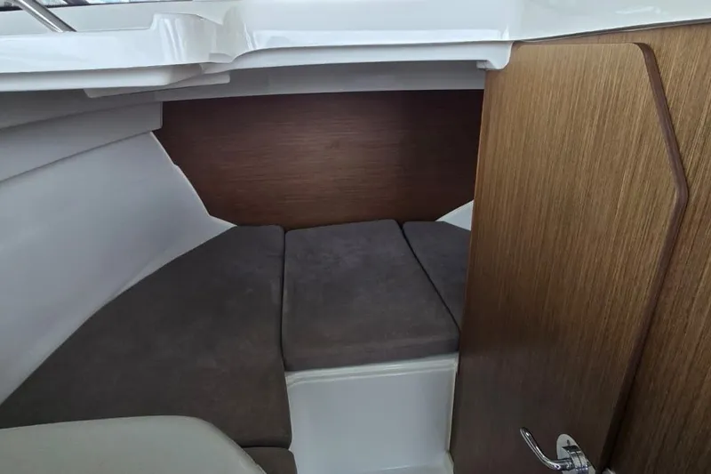 Slide: The Image of 2022 Beneteau Antares 7 cabin interior with cozy seating and wooden accents. - 15