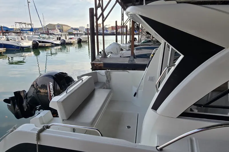 Slide: The Image of 2022 Beneteau Antares 7 docked at marina with Mercury outboard motor. - 5