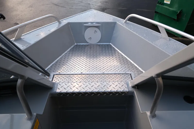 Slide: The Image of 2025 Hewescraft 180 Sportsman boat interior with diamond plate flooring. - 13