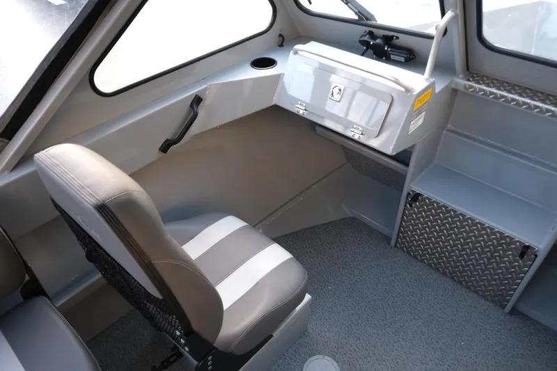 Slide: The Image of Interior of 2025 Hewescraft 180 Sportsman boat, featuring seating and storage. - 14
