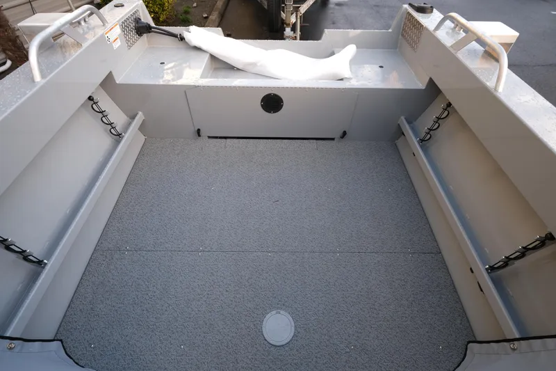 Slide: The Image of 2025 Hewescraft 180 Sportsman boat interior with spacious deck and storage compartments. - 7