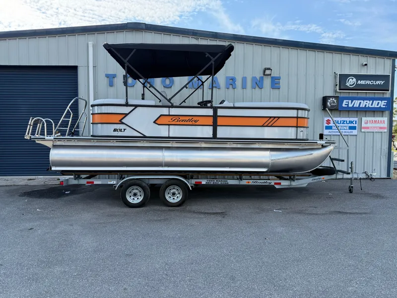Slide: The Image of 2025 Bentley Pontoons Bolt 203 on trailer, parked outside a marine dealership. - 11