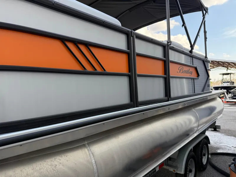 Slide: The Image of 2025 Bentley Pontoons Bolt 203 with orange accents and sleek design. - 14