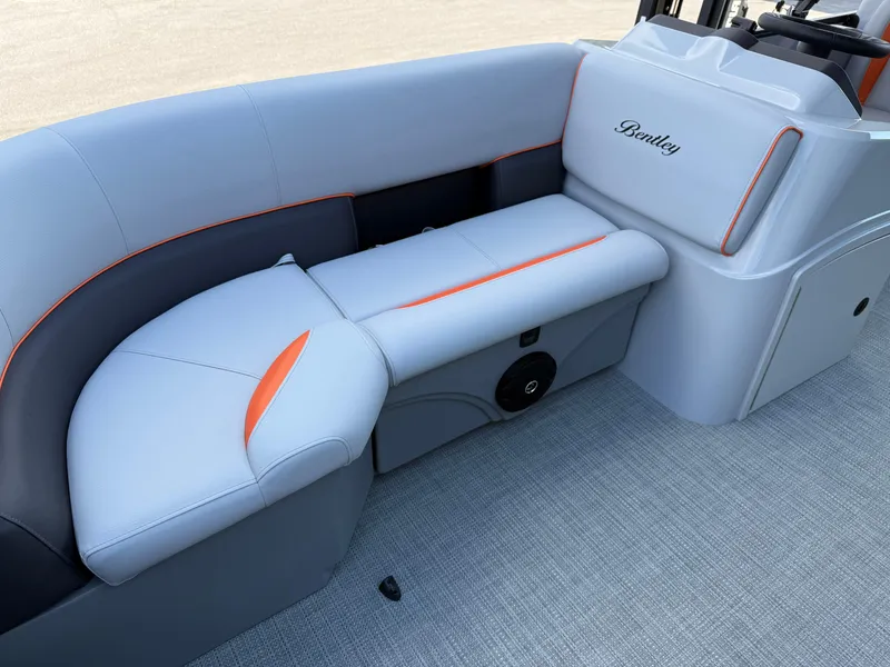 Slide: The Image of 2025 Bentley Pontoons Bolt 203 interior seating with modern design and orange accents. - 18