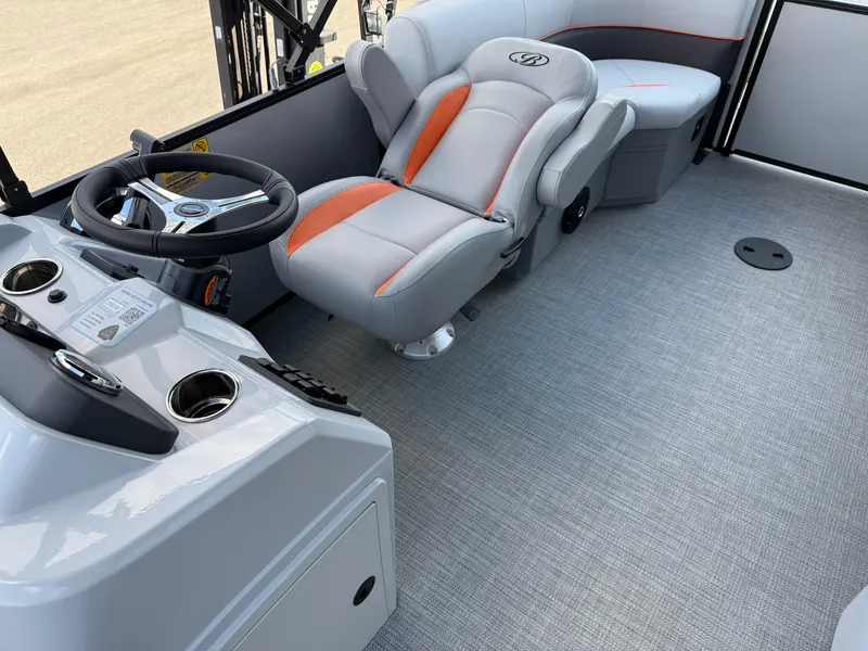 Slide: The Image of 2025 Bentley Pontoons Bolt 203 interior with gray and orange seating, steering wheel, and console. - 26