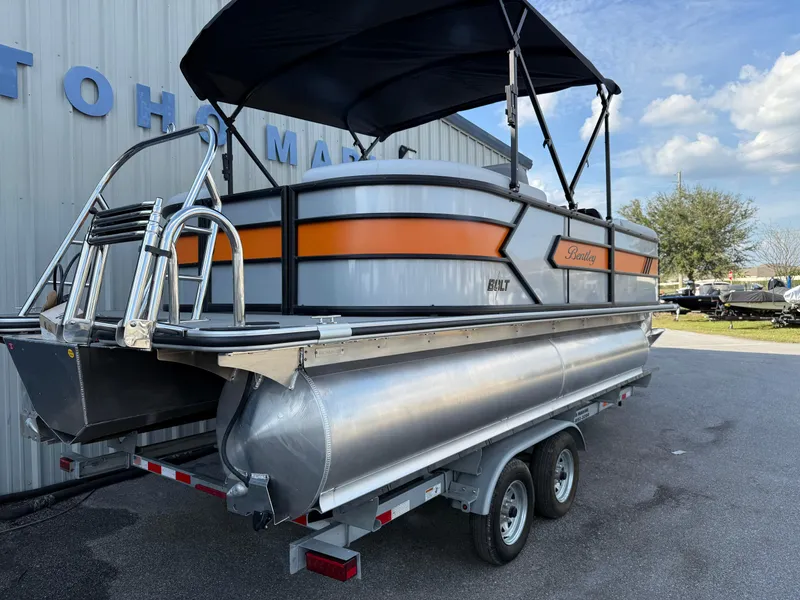 Slide: The Image of 2025 Bentley Pontoons Bolt 203 on trailer, featuring sleek design and vibrant orange accents. - 29