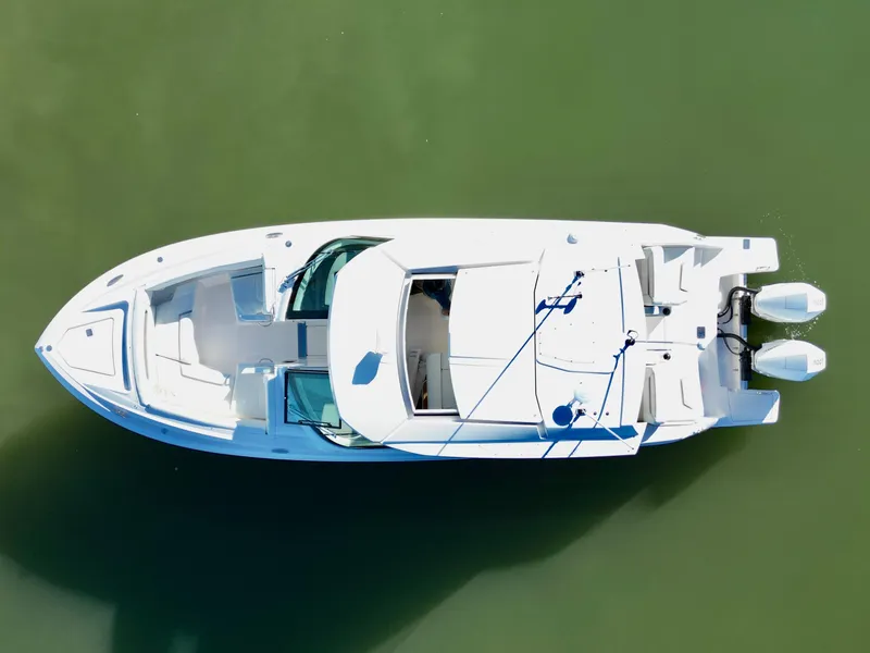 Slide: The Image of 2025 Tiara Yachts 34 LX boat, aerial view, on calm green water. - 27