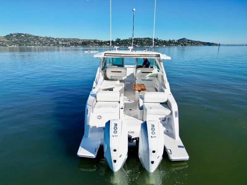 Slide: The Image of 2025 Tiara Yachts 34 LX on calm water, showcasing dual engines and sleek design. - 4